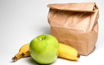 Bag lunch with a banana and an apple.
