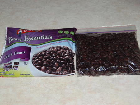 comparing packages of frozen black beans