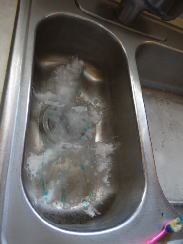 prepping stainless steel sink for natural cleaning with homemade mix