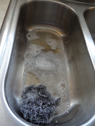 stainless steel sink cleaning dirty water after scrubbing