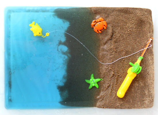 sand and beach toys in ocean sensory bin