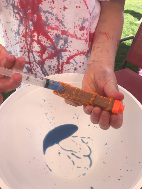 filling water gun with play paint